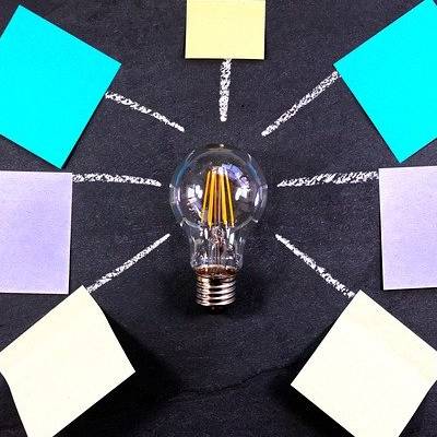 Light bulb with ideas and post it notes